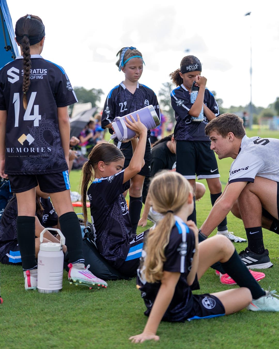 Players from the squad on the sideline between games.