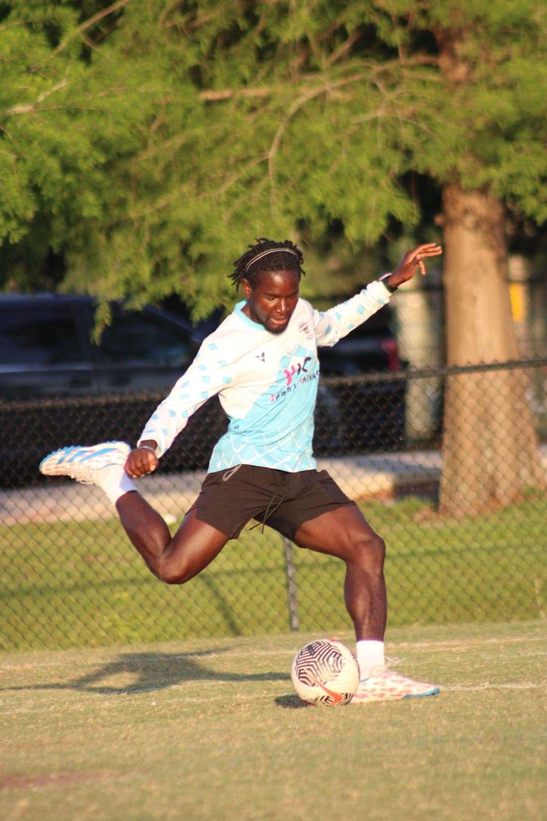 A Vic Sports Training coach striking a ball during a session.
